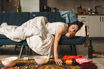 Young woman sleeping on sofa after house party