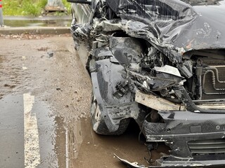 Car is severely damaged following a collision and road accident incident recently. This image...