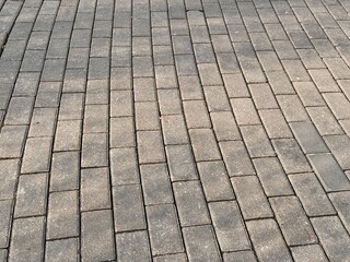 A detailed description of a Gray Paving Stones Pattern used in various outdoor settings. Clos-eup of modern gray paving stones, highlighting their intricate texture and careful arrangement