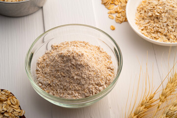 Oat flour in glass bowl.whole grain flour made from rolled oats.rich in nutrients.