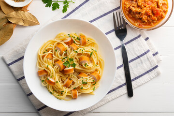 threaded spaghetti hot dog bites,sausage stuffed with spaghetti in white plate.