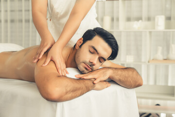 Caucasian man customer enjoying relaxing anti-stress spa massage and pampering with beauty skin...
