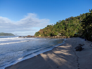 Deserted Barra do Sahy beach at dawn with small waves