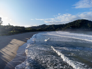 Deserted Barra do Sahy beach at dawn with small waves