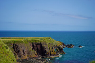 View of rocky cliff edge and sea in Scotland in the summer