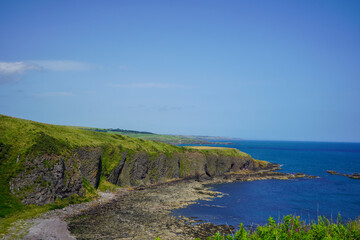 View of rocky cliff edge and sea in Scotland in the summer