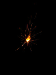 Fototapeta premium Burning squib on a black background with sparks.