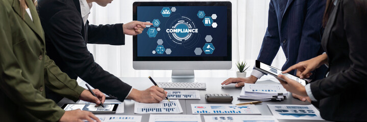 Panorama shot analyst team utilizing BI Fintech to analyze financial report with laptop. Businesspeople analyzing BI data dashboard displayed on laptop screen for business insight. Prodigy © InfiniteFlow