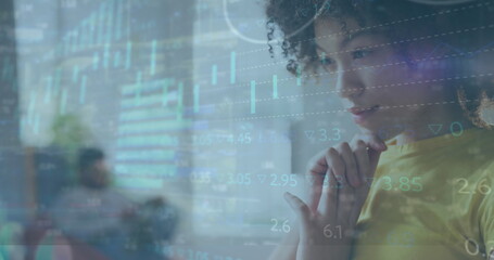 Analyzing woman wearing yellow shirt viewing digital financial charts in office lounge, copy space