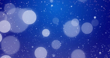 Blending deep blue violet gradient winter scene with bokeh circles falling snowflakes and particles
