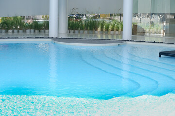 Empty swimming pool with sunbed and white modren resort hotel for vacation leisure and white...