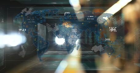 Displaying digital world map projection on glass corridor wall, with hex grid nodes and data lines