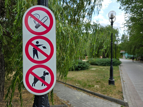Informational notice no smoking, no littering, no dogs on a summer day in the park. Stop pollution. Protection of nature. Social rules