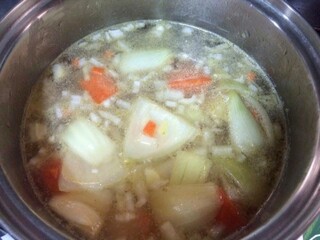 Cooking of Chicken clear soup with carrot, onion, potato, boiling on white, bowl of chicken broth soup with vegetables in stainless pot