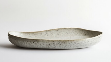 Obraz premium Elegant Handcrafted Ceramic Dish with Unique Shape and Textured Surface for Table Presentation and Decorative Use