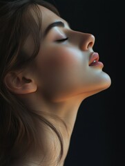 Fototapeta premium Beautiful woman looking up in profile with eyes closed on dark background