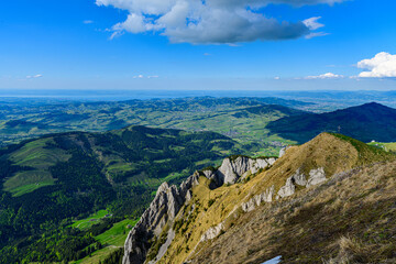 Stunning panoramic view of rolling hills and valleys under a clear blue sky in the mountains during...