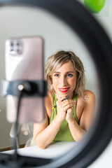 Influencer recording video content with ring light and smartphone