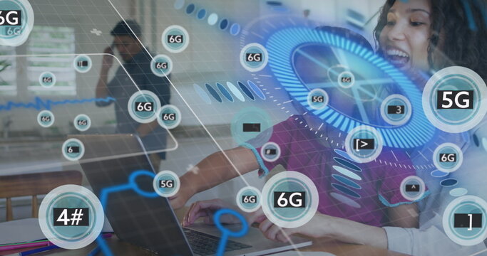 Typing curly-haired woman leaning over laptop at office desk, digital network graphics, copy space