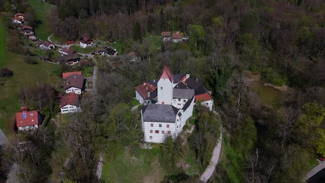 Aerial view of Schloss Elkofen, historic Bavarian castle nestled in green meadows near Grafing, Upper Bavaria. Scenic medieval landmark, blending nature, heritage, timeless architecture. Burg Elkofen