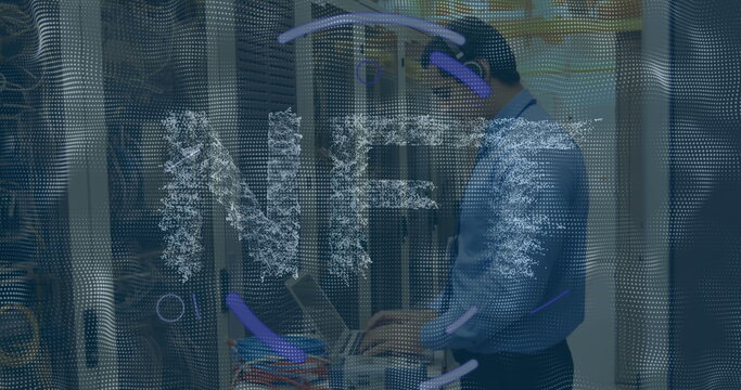 IT technician in blue shirt operating rack-mounted laptop in data center, with colorful cables