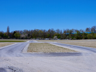Damaged asphalt road under blue sky