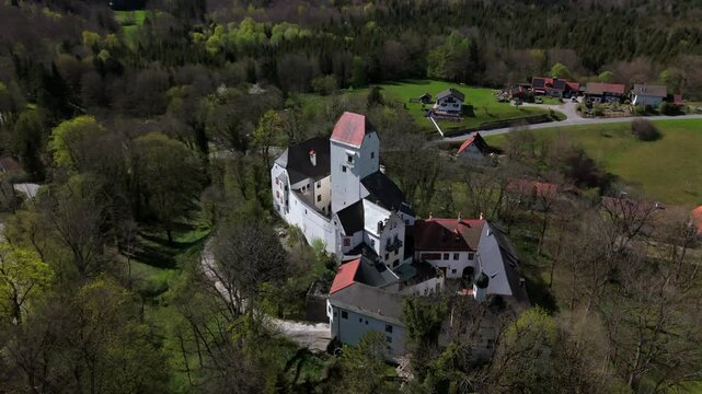 Aerial view of Schloss Elkofen, also known as Burg Elkofen, Schloss Elkhofen, near Grafing bei Muenchen, Germany. A medieval fortress surrounded by green fields in the Bavarian countryside. 