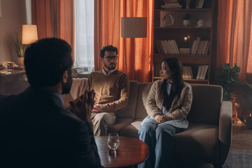 Fototapeta premium Man and woman quarrel during session with male psychologist