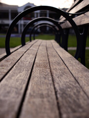 Selective focus shot of an empty bench in a garden