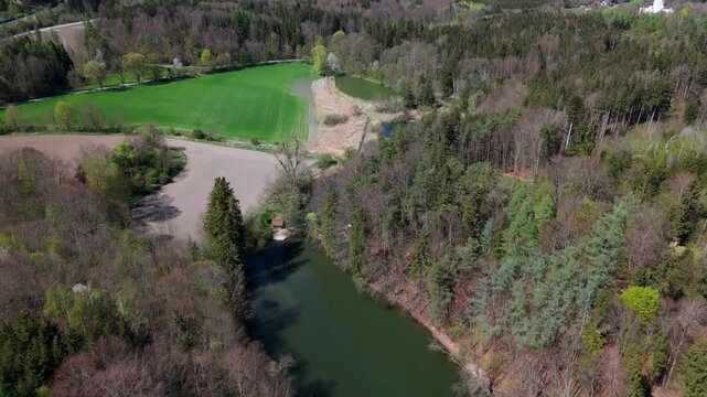 Luftaufnahme Spiegelweiher and surrounding ponds in Bavaria, Germany, Grafing bei Munchen. Scenic spring landscape with shimmering lakes, tranquil paths and flourishing nature in southern Deutschland