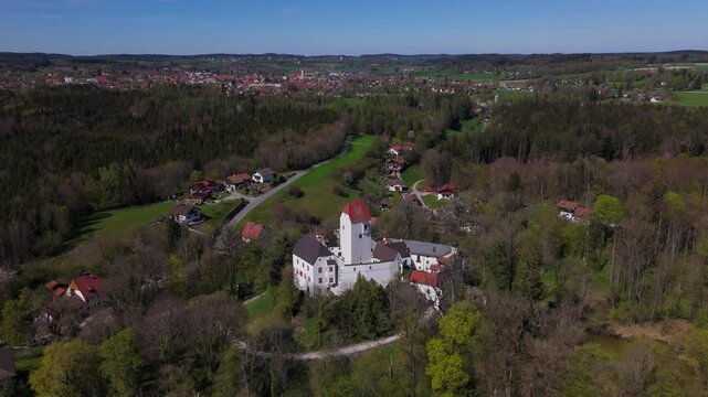Aerial view of Schloss Elkofen, historic Bavarian castle nestled in green meadows near Grafing, Upper Bavaria. Scenic medieval landmark, blending nature, heritage, timeless architecture. Burg Elkofen