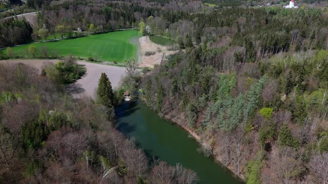 Drone shot of Spiegelweiher, fish pond chain in Grafing bei Muenchen, Bavaria, Germany. This hidden gem near Munich features quiet hiking trails, reflective waters and vibrant spring greenery. 