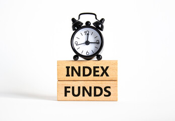 Index Funds symbol. Concept words Index Funds on wooden blocks. Beautiful white background with alarm clock. Business and Index Funds concept. Copy space.