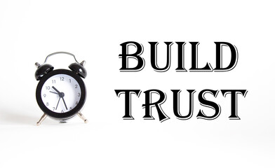 Build trust symbol. Beautiful white background with alarm clock. Business and Build trust concept....