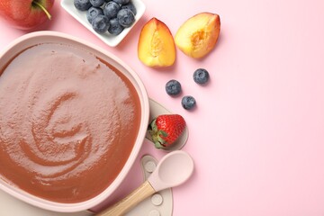 Baby food. Tasty puree in bowl, spoon and ingredients on pink table, flat lay. Space for text