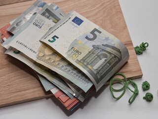 Closeup shot of a pile of five and ten Euro banknotes