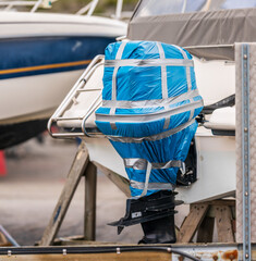 Wrapped outboard engine on boat prepared for storage.