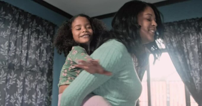 Mom, daughter and piggyback. Spinning, dancing and fun in living room. High quality 4k footage