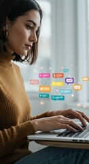 Woman using laptop with colorful social media icons for digital communication