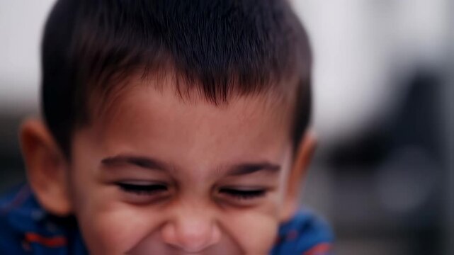 Joyful child's uncontrollable laughter in slow motion closeup sequence