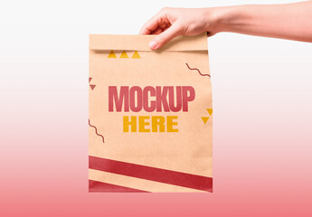 Hand Holding a Paper Kraf Bag Mockup