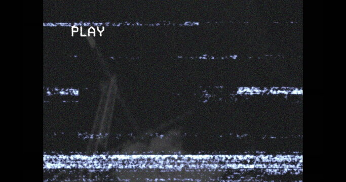 Displaying VCR player screen at home showing horizontal static lines, with pixelated PLAY text - Powered by Adobe