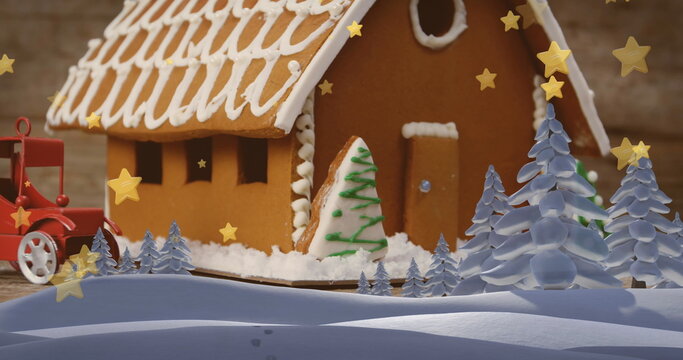 Fototapeta Gingerbread house sitting on wooden table, red toy truck, pine trees and gold confetti