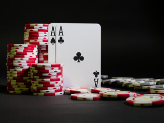 Closeup shot of poker cards and chips on a black background