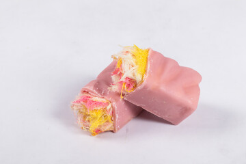 Vegan dessert. Angel Hair. Modern Raspberry white chocolate candy bar. With colored cotton candy. White background. Close-up.