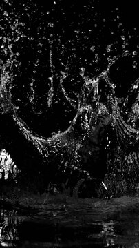 Super Slow Motion of Flying Water Splashes. Filmed on High Speed Cinema Camera, 1000fps. Vertical Aspect Ratio.