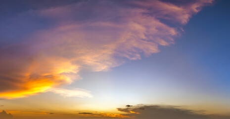 Beautiful sunset sky scenery. Bright colorful orange and yellow clouds on horizon
