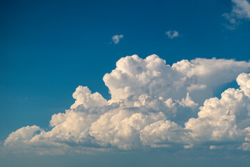 Bright landscape of blue sky with flying white clouds. Colorful summer skyscape