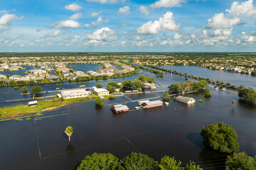 Farmland area flooded after hurricane rains. Underwater farm buildings under rainfall water in...