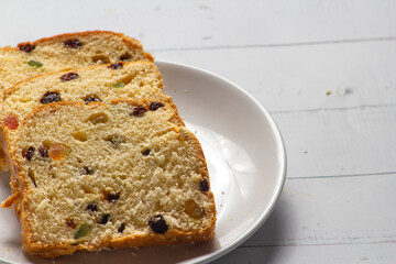 Slices of Traditional Sweet Fruit Bread on Wooden Board